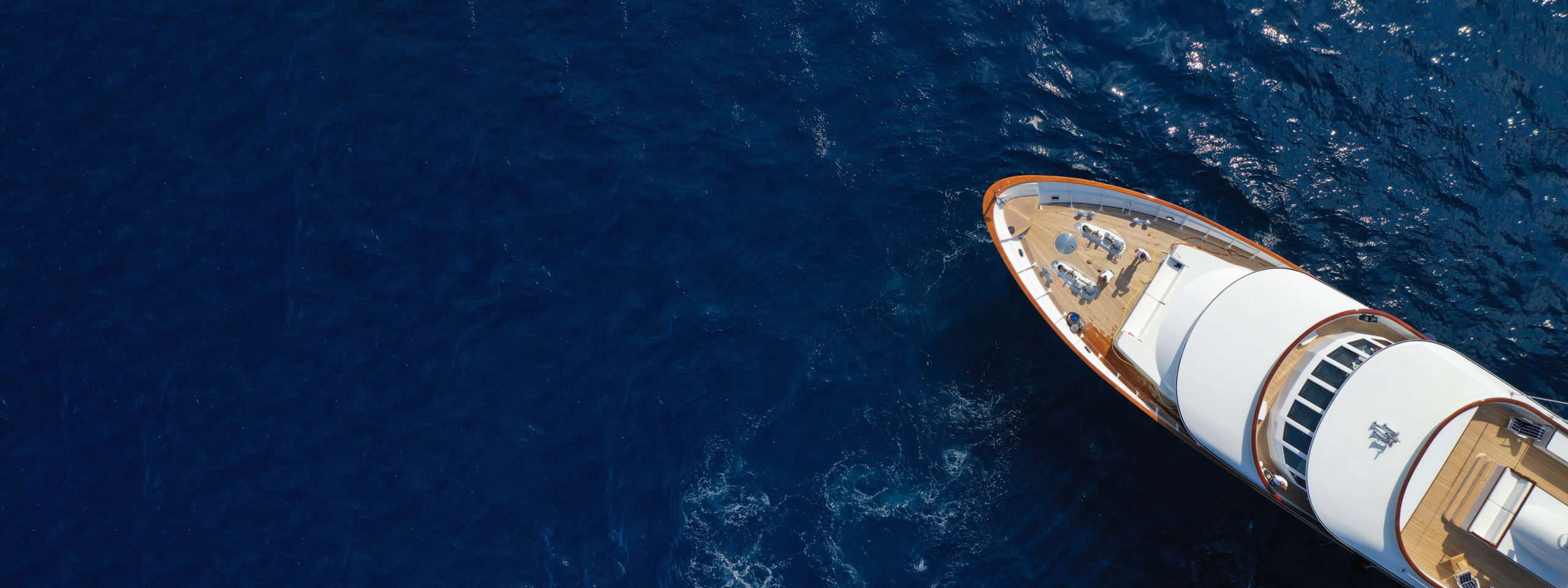 Aerial drone ultra wide photo of luxury yacht with wooden deck a