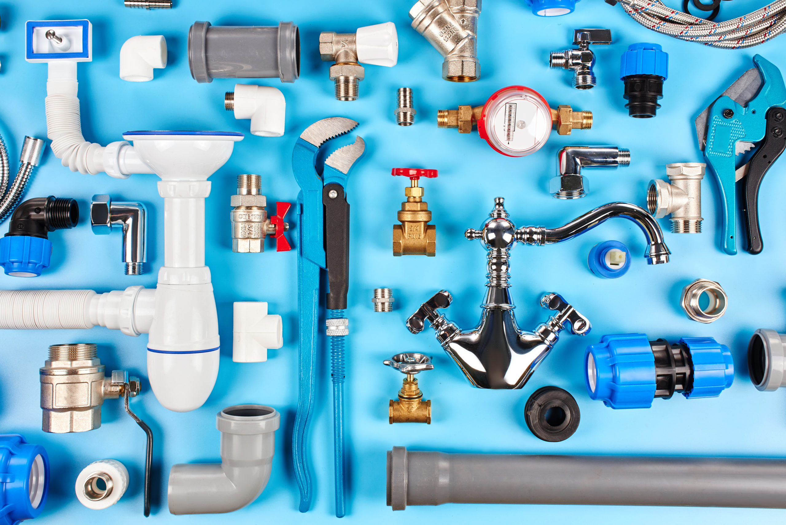 plumbing tools and equipment on blue background top view